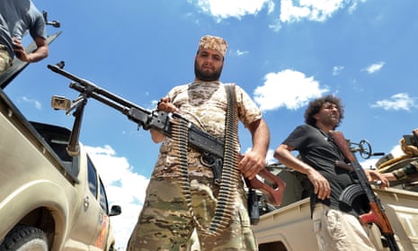 Fighters loyal to the UN-recognised Libyan government in Tripoli secure the area of Abu Qurain in July.