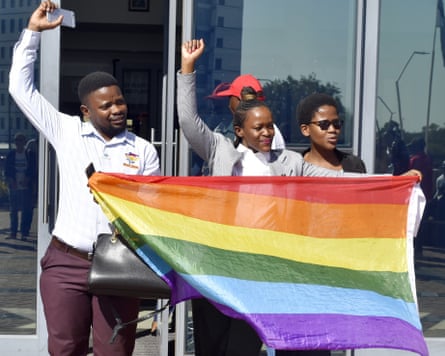 People holding a rainbow flag
