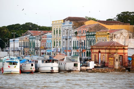 Old colourful buildings and boats on a river in Brazil