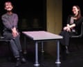 Christine and Lois Mackie smile while seated on stage, separated by a small table