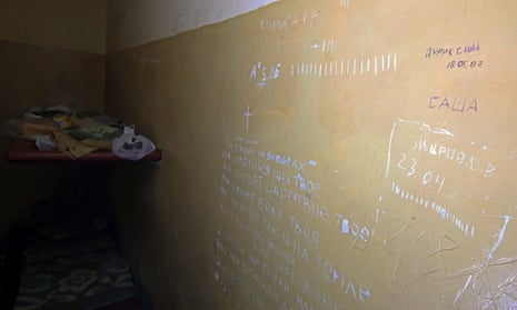 The words of the Lord’s Prayer are written on the wall of a cell at the District Police Department in Balakliia.