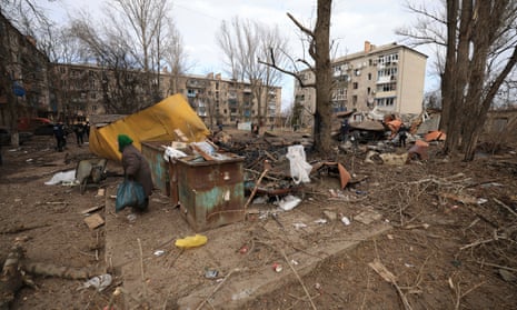 A woman walks through a residential neighbourhood after a Russian attack on Kostiantynivka