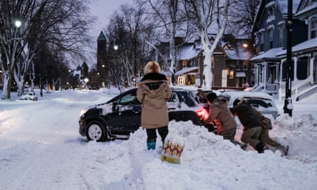 US braces for more deaths as ‘blizzard of the century’ grips nation | US news 1 Members of the New York National Guard help to free a car stuck in the snow in Buffalo, New York