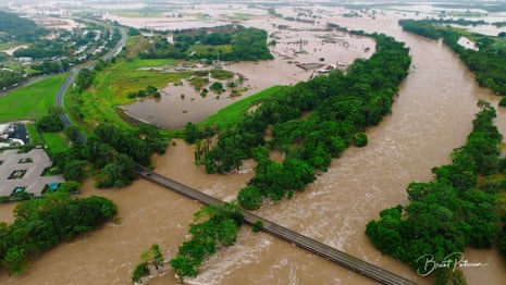 An aerial view of the flooding in Cairns and water surging along the Barron River.