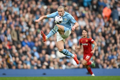 Erling Haaland of Manchester City controls the ball in the air.