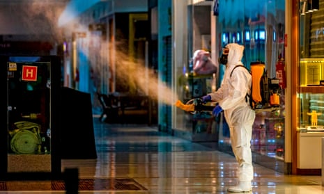 An employee wearing protective gear disinfects a shopping mall as a preventive measure against the COVID-19 coronavirus in Caxias do Sul, Brazil.