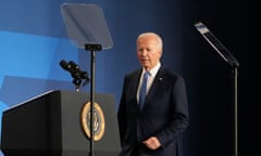 a man in a suit walks towards a lectern