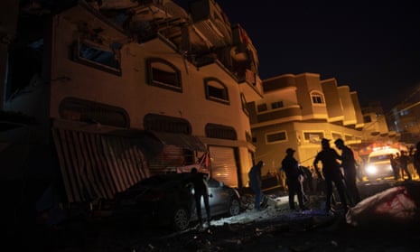 Palestinians check the damage of a house targeted by Israeli missile strikes in Gaza City.
