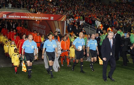 Assistant referee Darren Cann (left), fourth official Yuichi Nishimura (second right), referee Howard Webb and assistant referee Michael Mullarkey lead out the players at the 2010 World Cup final.