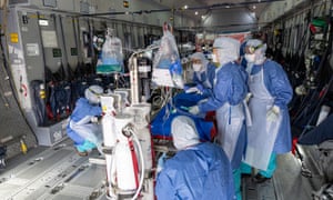 Medical staff check equipment installed in an Airbus A400M prior to an evacuation of patients infected with Covid-19 at Guiana air-base in Matoury, near Cayenne.