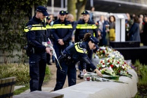 Emergency workers lay flowers during a commemorative event