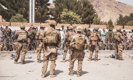 US armed forces personnel assist with security at an evacuation control checkpoint at Hamid Karzai international airport.