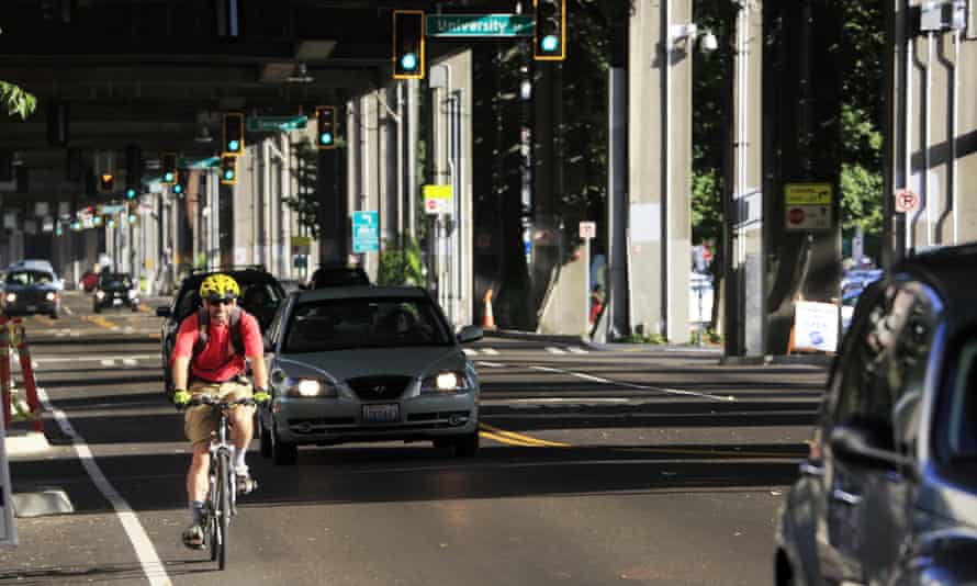 A Seattle cyclist wearing the mandatory helmet.