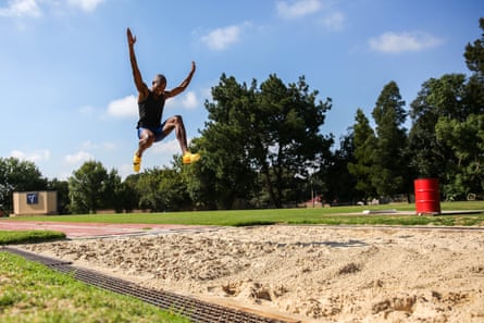 Luvo Manyonga jumps into a sand pit