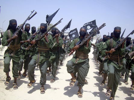 A group of uniformed men pinch weapons marching