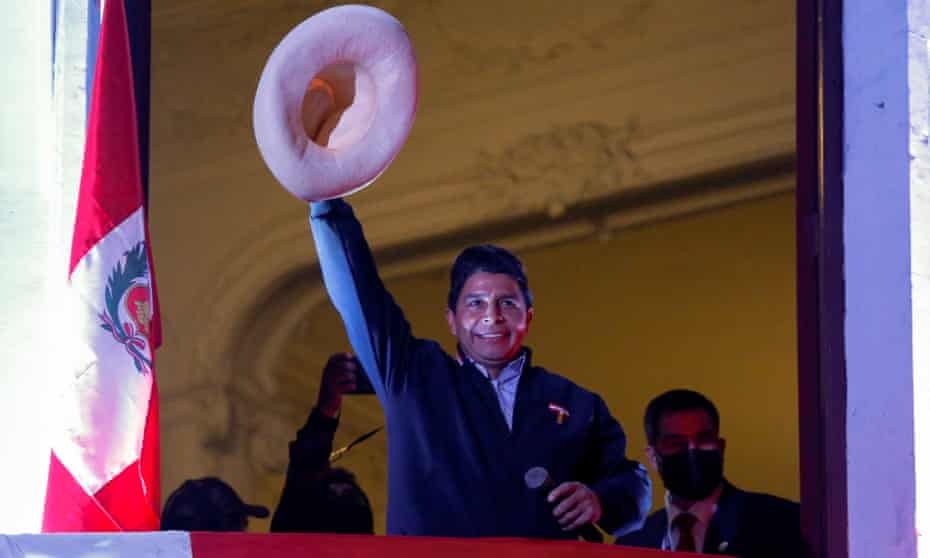 Leftwing presidential candidate Pedro Castillo of the Perú Libre party gestures to his supporters from the balcony of his party headquarters in Lima after his election win.