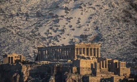 The ancient Acropolis hill with the Parthenon temple, left, and the Propylea, right, in front of the snowy Hymettus mountain, in Athens, on 17 February, 2021.