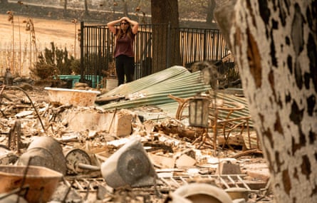 A resident looks over the charred remains of her family home in Vacaville, California.