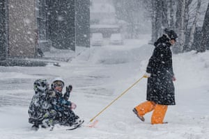 Yuzhno-Sakhalinsk, Russia. A woman take children for a walk during a heavy snowstorm brought by a cyclone from Japan to Russia’s Sakhalin Island