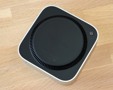 The bottom of the Mac mini M6 showing the exhaust vents and the power button.