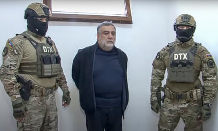 Vardanyan is escorted by Azerbaijan security service officers after being detained while trying to cross into Armenia.