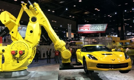 Industrial robots holding a sports car