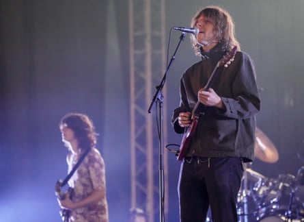 Two members of the rock band Geese playing guitar on stage