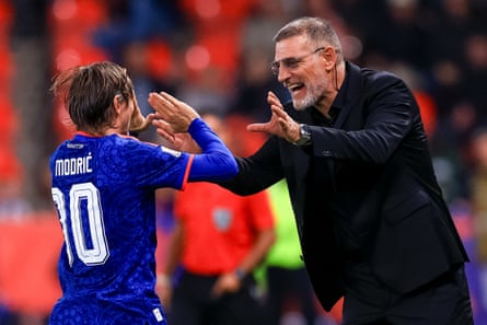 Luke Modric celebrates with Slaven Bilic.