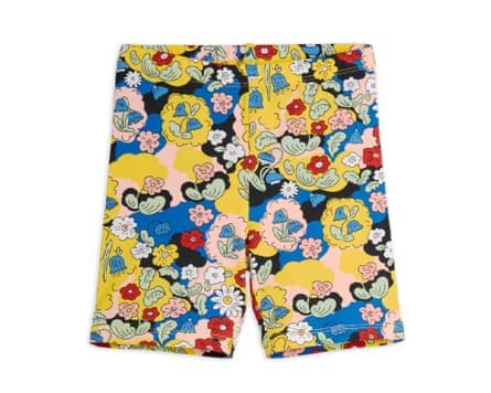 Kids’ bike shorts with a multicoloured floral pattern on a white background