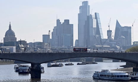 View of the City of London financial district with a bridge crossing the Thames in foreground