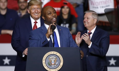 Tim Scott speaks in front of Donald Trump and Lindsey Graham in North Charleston, South Carolina in February 2020.