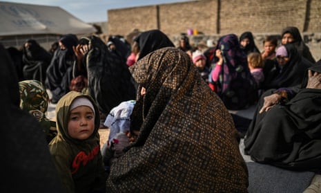 Women waiting to have their children checked for signs of malnutrition at a camp for internally displaced people on the outskirts of Herat