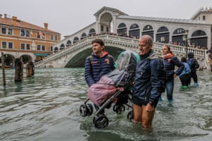 Tourists carry a stroller