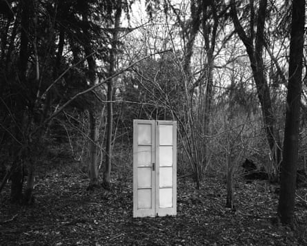 B/W image of door in wooodland.