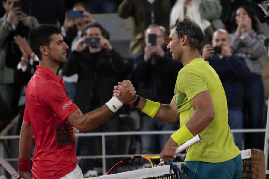 Novak Djokovic (left) congratulates Rafael Nadal who won the quarter-final match in four sets, 6-2, 4-6, 6-2, 7-6 (7-4).