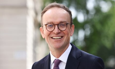 Jeremy Pocklington: a head and shoulders official portrait. He is 50 years old with glasses and short, receding fair hair; he wears a dark suit and tie and is smiling