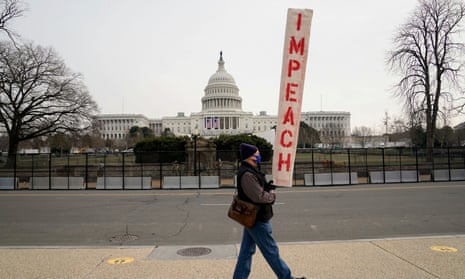 A demonstrator holds a sign reading “Impeach” outside the U.S. Capitol days after supporters of U.S. President Donald Trump stormed the Capitol in Washington, U.S. January 11, 2021. REUTERS/Erin Scott