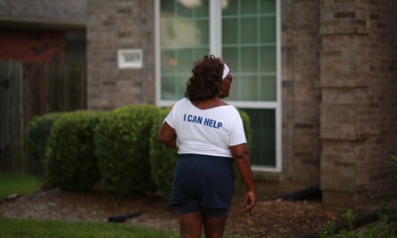The back of Cynthia Ginyard’s shirt, reading ‘I can help’, is seen as she canvasses in Sugar Land.