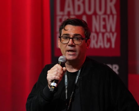 Andy Burnham speaking into a mic