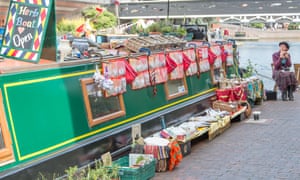 Sue Cotton sells herb plants on the roof of her boat.