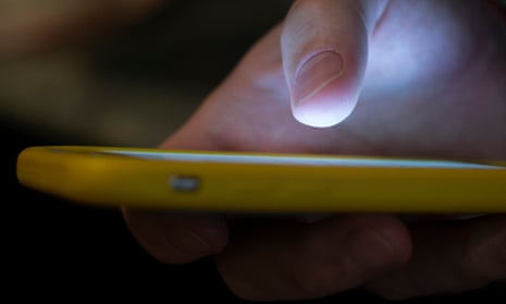 close up of a hand holding an iphone in a yellow case