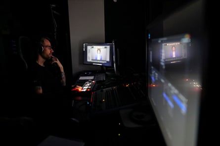 man with headphones on working at a computer terminal