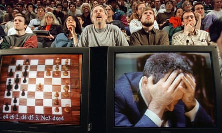 Chess enthusiasts watch Garry Kasparov on a monitor  at the start of the sixth and final match against IBM’s Deep Blue computer in New York.