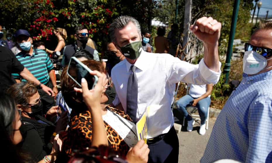 Gavin Newsom’s political fate in balance as polls close in California recall | Gavin Newsom 1 Gavin Newsom takes photos with supporters after a rally in Oakland on Saturday.