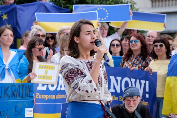 A protestor speaks outside the EU–western Balkans summit in Brussels.