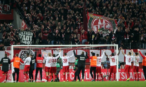 The FC Cologne players celebrate with their fans after beating Bayer Leverkusen 2-0 in December 2019. 