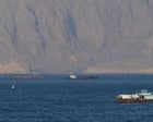 Middle East crisis live: tanker hit by ‘projectiles’ in strait of Hormuz after Trump says US will help ‘guide’ stranded ships