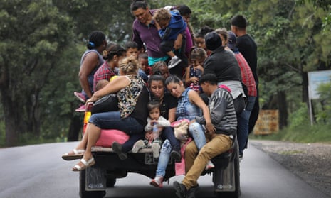 Honduran immigrants travel north near Quezaltepeque, Guatemala, on 16 October.