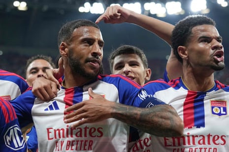 Lyon's Corentin Tolisso is embraced by teammates celebrating a goal