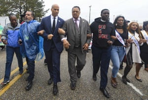 Booker and the Rev Jesse Jackson march to cross the Edmund Pettus Bridge in Selma, Alabama earlier this month.